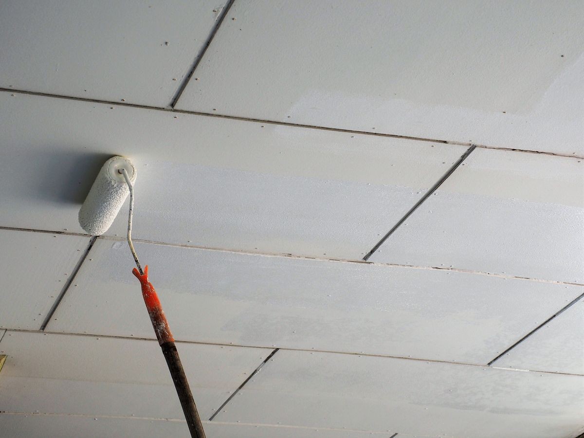 Re-paint gypsum board ceiling with white acrylic paint by using long handle roller.